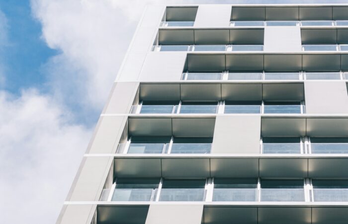 white high-rise building under white and blue skies